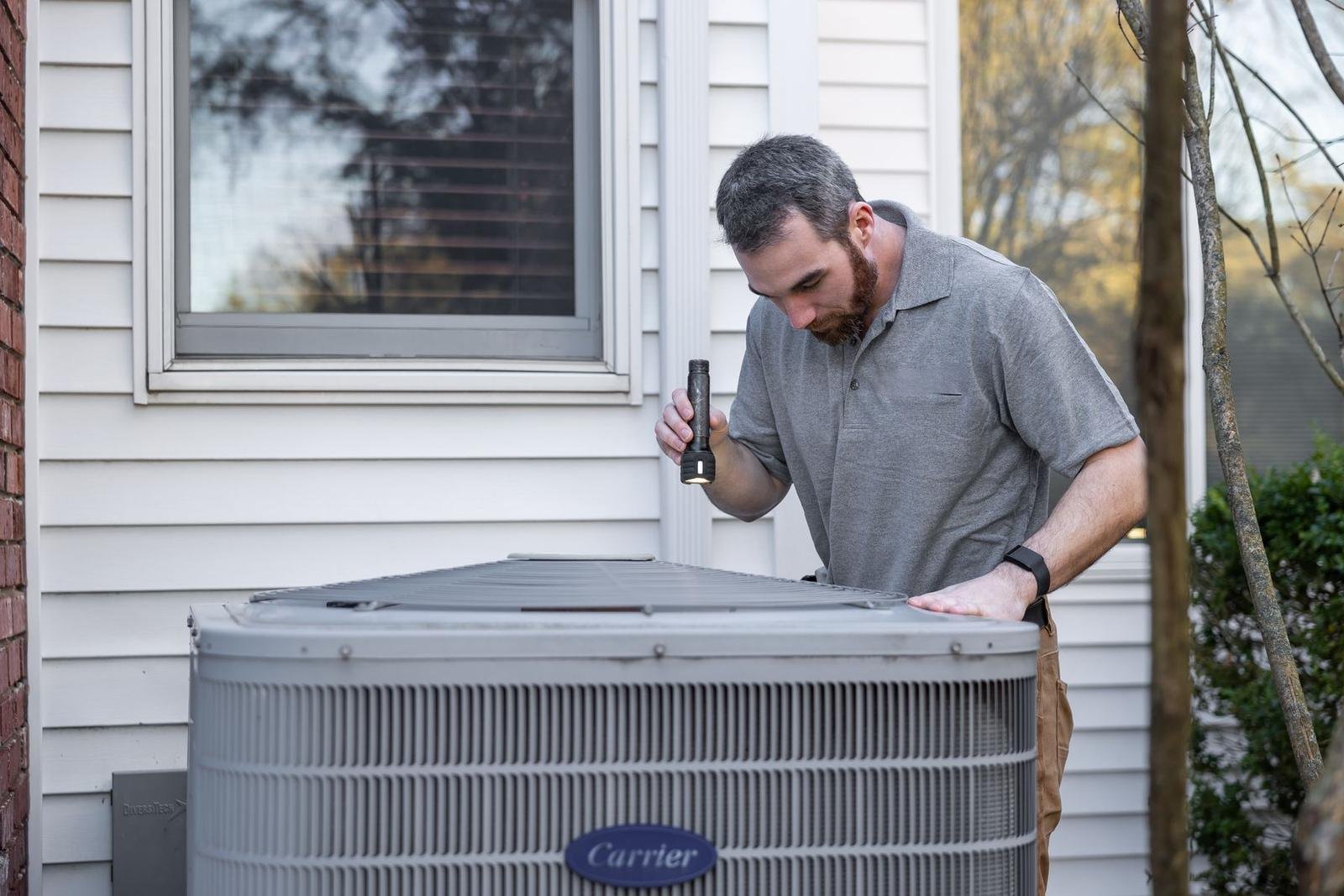 Technician inspecting an AC unit